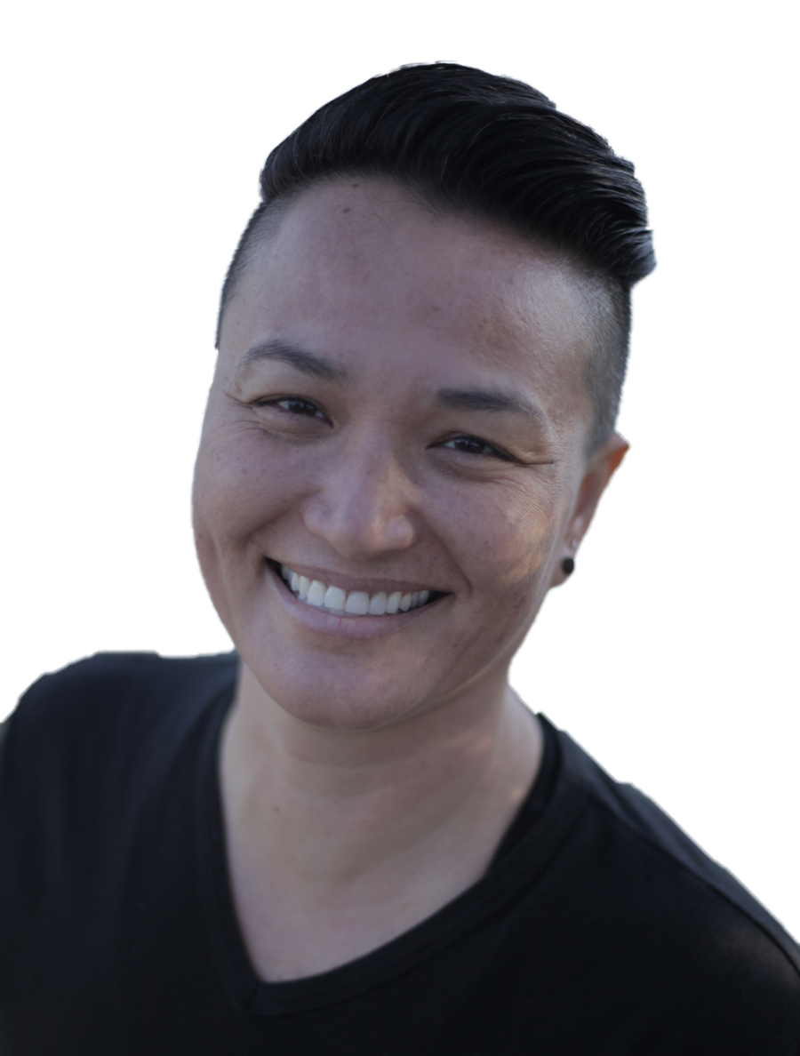 bust of Natalie Thoreson wearing black V-neck with their hair brushed back on top and shaved close on the sides